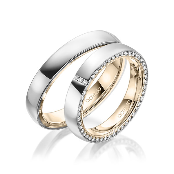 Set Bicolor Memoire-trouwringen in buiten witgoud 14 kt. , binnen Signature Goud 585 volledig gezet met in totaal 0,279 ct. Briljant tw/si van acredo