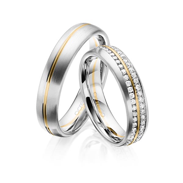 Set Bicolor Memoire-trouwringen in witgoud 14 kt. geelgoud 14 kt. volledig gezet met in totaal 0,784 ct. Briljant tw/si van acredo
