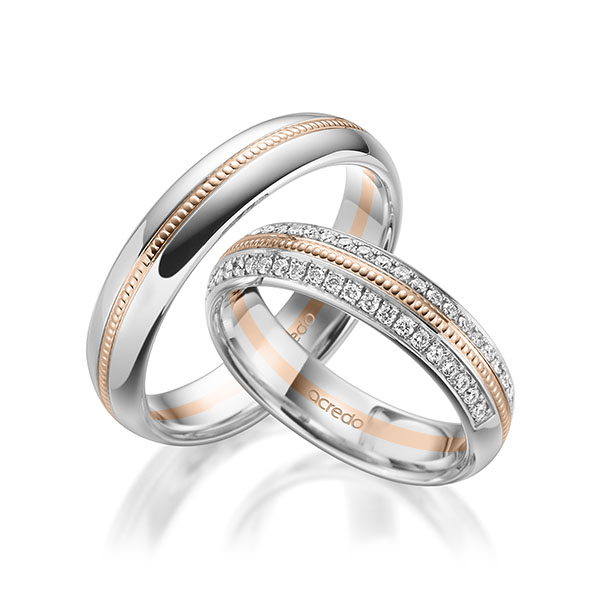 Set Bicolor Memoire-trouwringen in witgoud 14 kt. roodgoud 14 kt. half gezet met in totaal 0,384 ct. Briljant tw/si van acredo Set Bicolor Memoire-trouwringen in witgoud 14 kt. roodgoud 14 kt. half gezet met in totaal 0,384 ct. Briljant tw/si van acredo