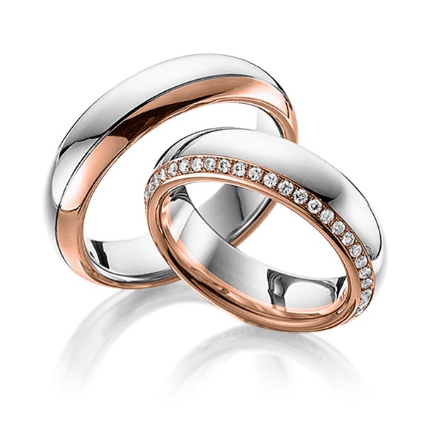 Set Bicolor Memoire-trouwringen in witgoud 14 kt. roodgoud 14 kt. volledig gezet met in totaal 0,47 ct. Briljant tw/si van Eternal Touch