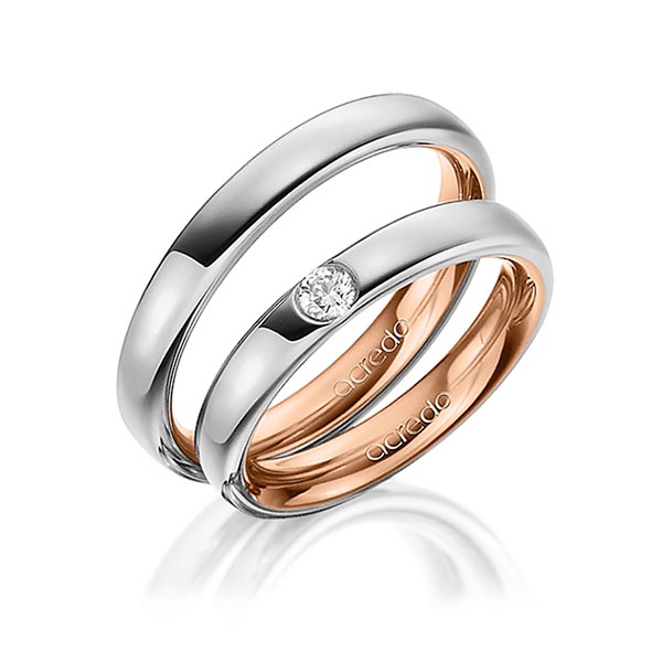 Set Bicolor trouwringen in buiten grijsgoud 14 kt. , binnen roodgoud 14 kt. met in totaal 0,12 ct. Briljant tw/si van acredo