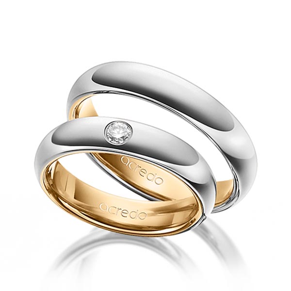 Set Bicolor trouwringen in buiten grijsgoud 14 kt. , binnen roségoud 14 kt. met in totaal 0,1 ct. Briljant tw/si van acredo