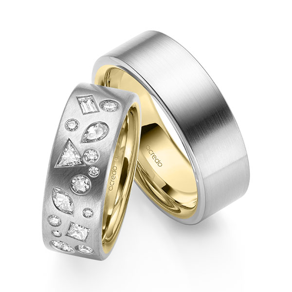 Set Bicolor trouwringen in buiten witgoud 14 kt. , binnen geelgoud 14 kt. met in totaal 0,9 ct. Princess-Diamant & Baguette-Diamant & Briljant tw/si tw,vs van acredo