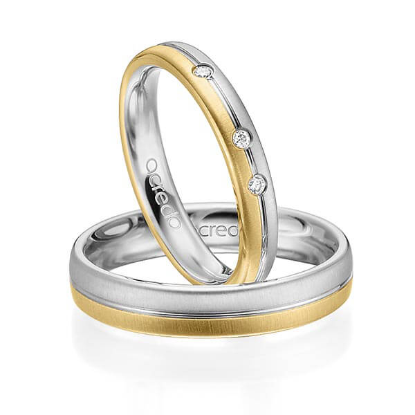 Set Bicolor trouwringen in witgoud 14 kt. geelgoud 14 kt. met in totaal 0,03 ct. Briljant tw/si van acredo