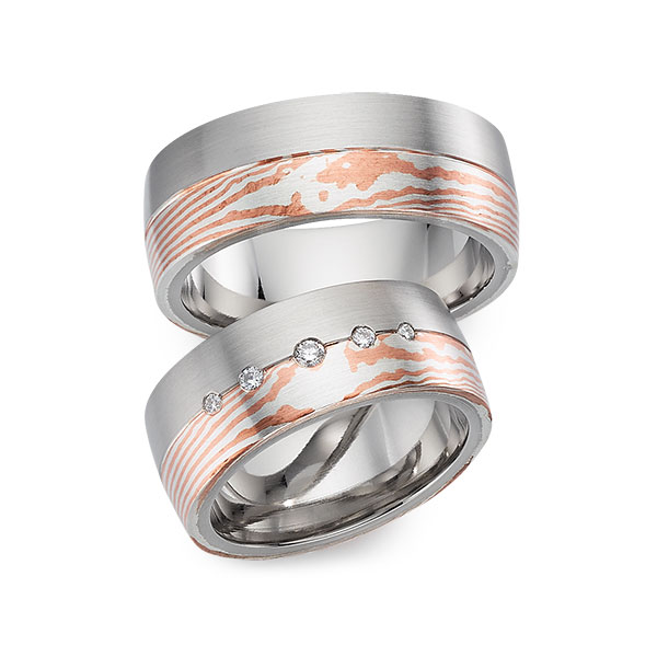 Set Bicolor trouwringen in witgoud 14 kt. Mokume Gane silver 925 copper met in totaal 0,09 ct. Briljant tw/si 