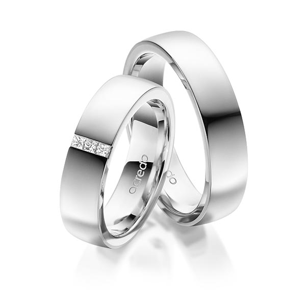 Set klassieke trouwringen in buiten witgoud 14 kt. , binnen witgoud 14 kt. met in totaal 0,09 ct. Princess-Diamant tw/si van acredo